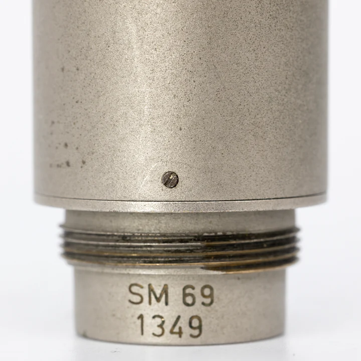 Close-up of engraved SM69 serial number on microphone body
