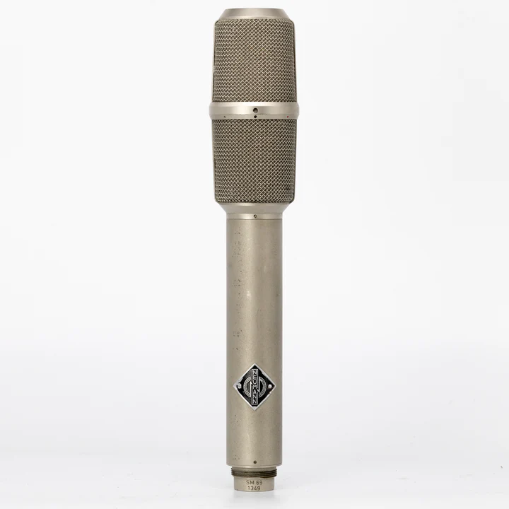 Vintage Neumann SM69 tube microphone standing upright against white background